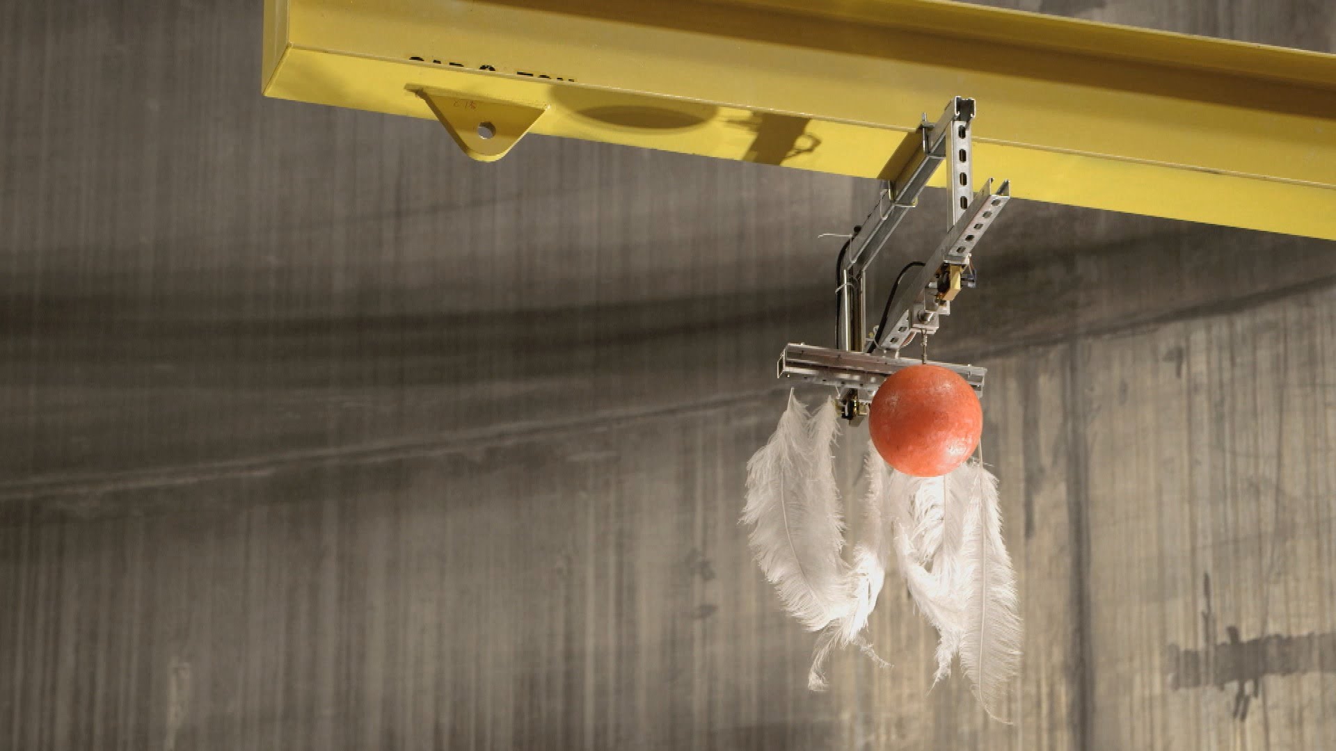 Bowling Ball and Feather Dropped in Largest Vacuum Chamber
